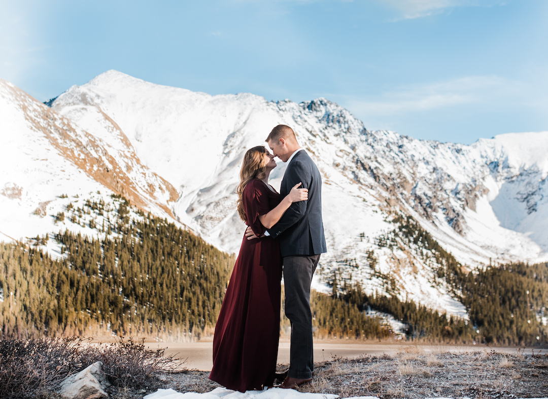 Taylor and Chris looking at each other on Loveland Pass with mountains in background