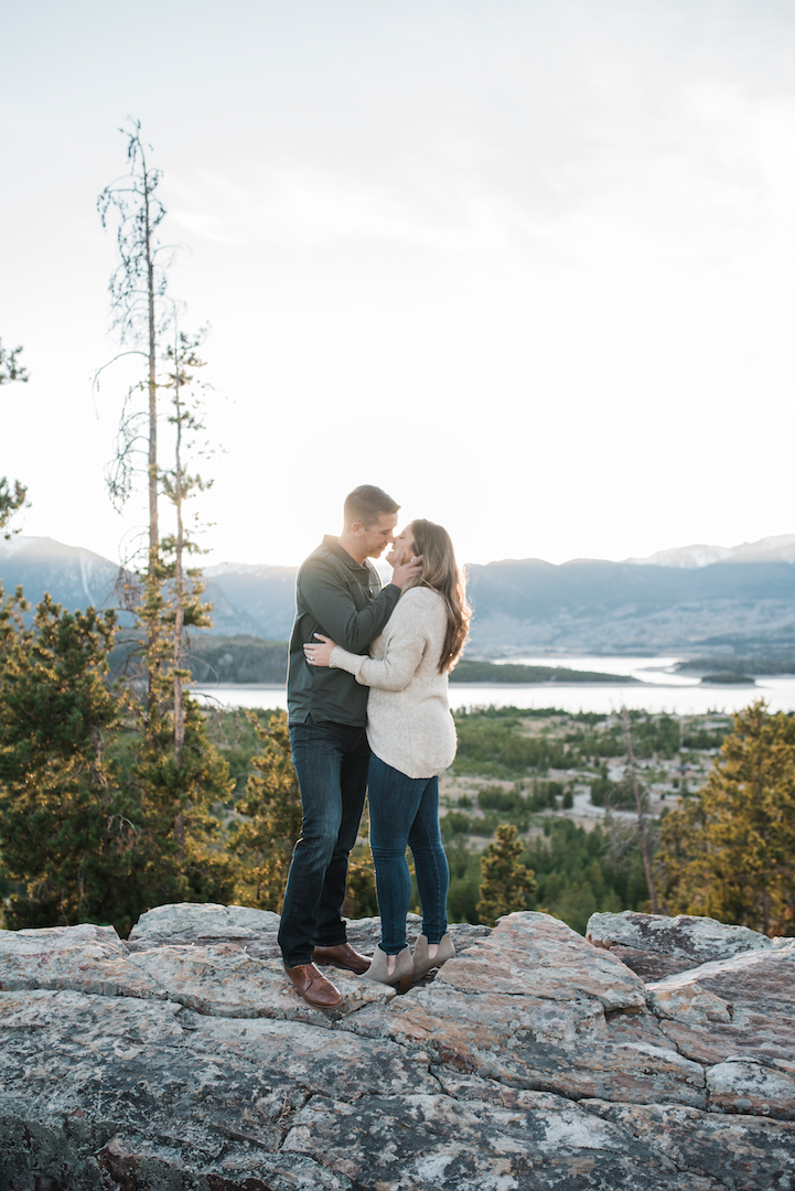Taylor and Chris kissing with Lake Dillon and mountains in background - far away