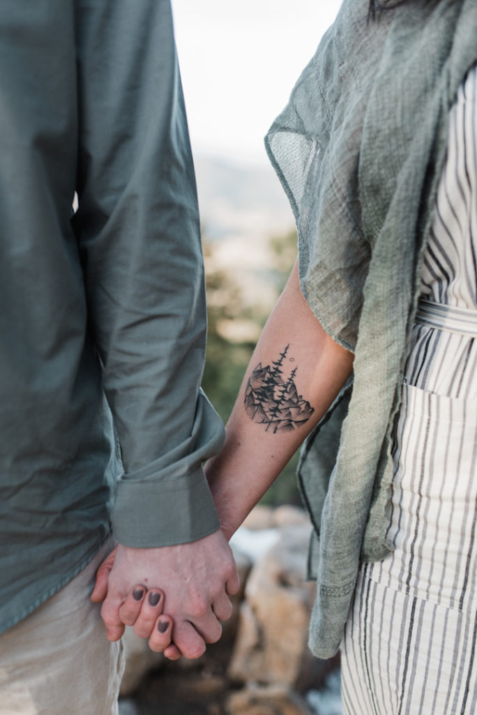 Girl mountain tattoo holding hands
