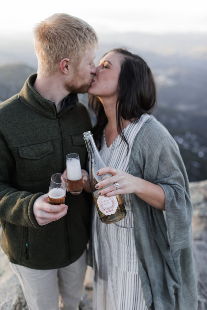 Couple with champagne kissing in Boulder at golden hour
