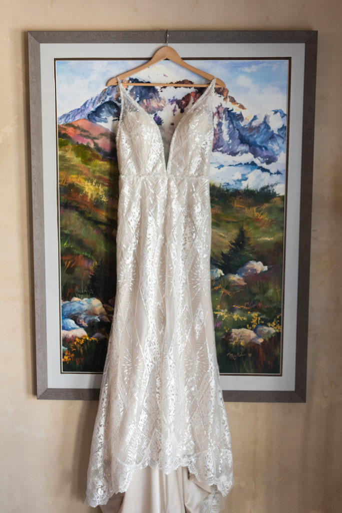 Wedding dress hanging over mountain painting