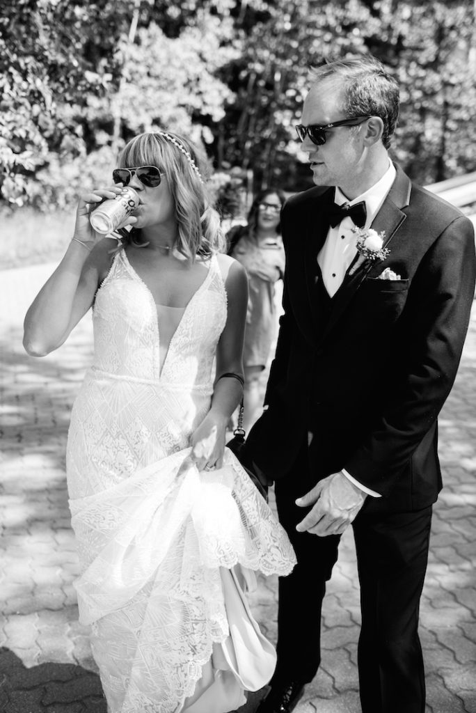 Bride and groom drinking beer black and white