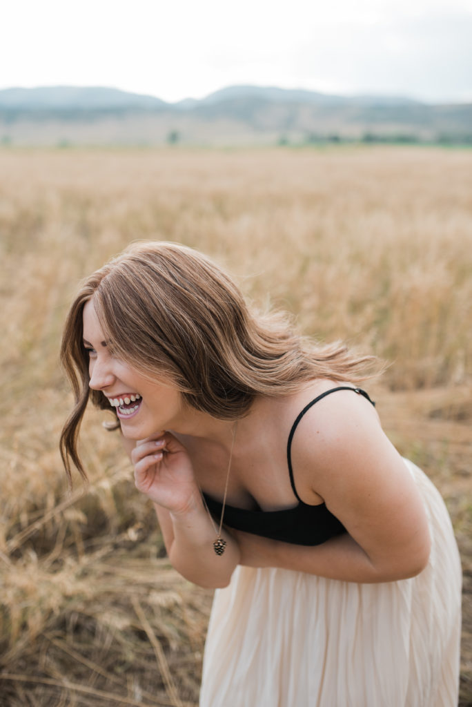 Kelsey laughing bent over in fort collins field