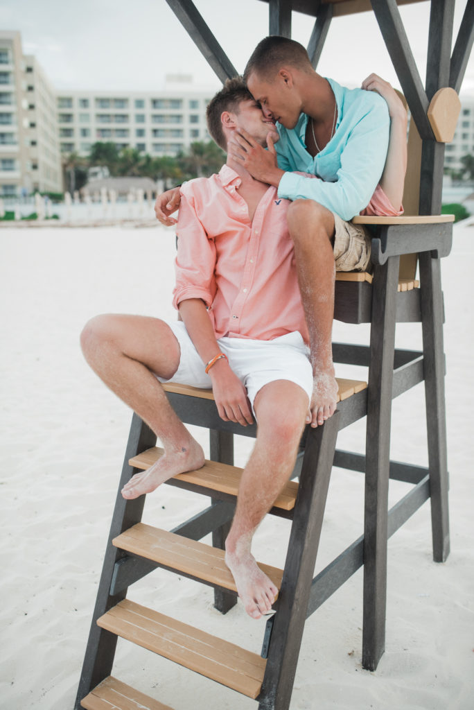 Cancun beach lovers shoot, sitting on lifeguard chair kissing