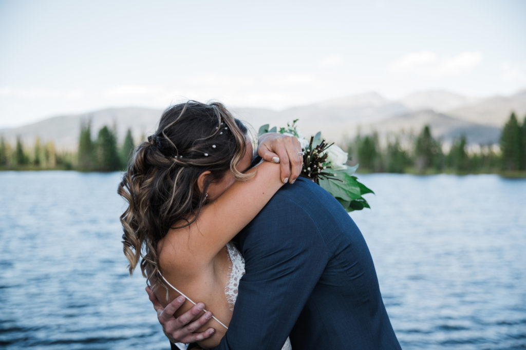 Kathryn and Phil hugging at Grand Lake wedding