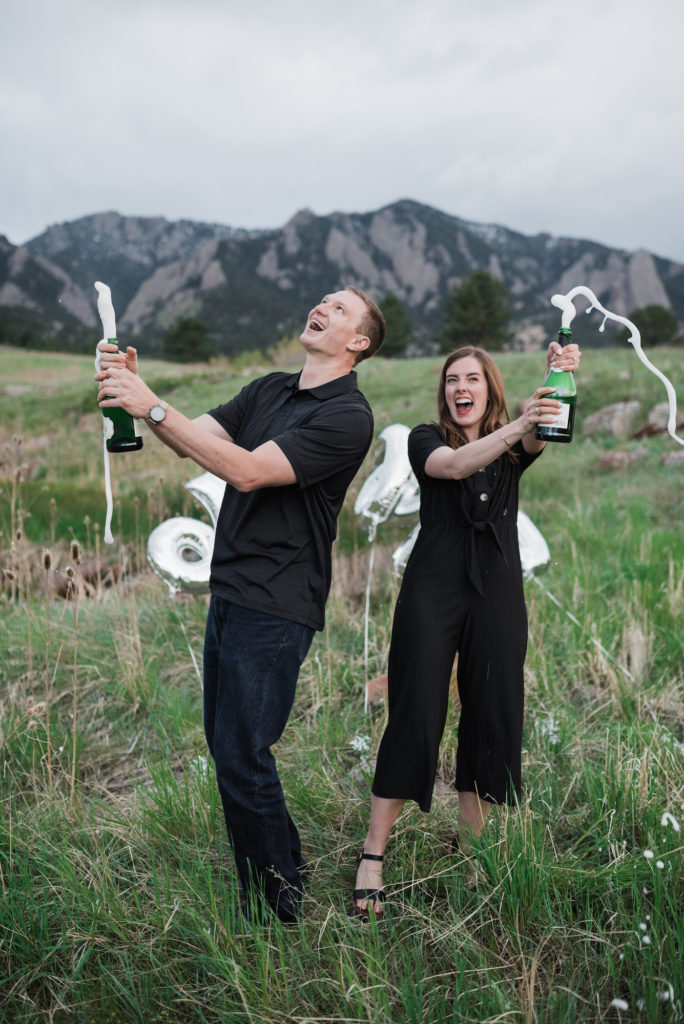 Catherine and Zach popping champagne at Boulder engagement