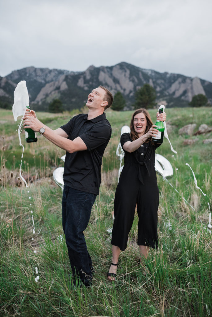 Catherine and Zach popping champagne at Boulder engagement