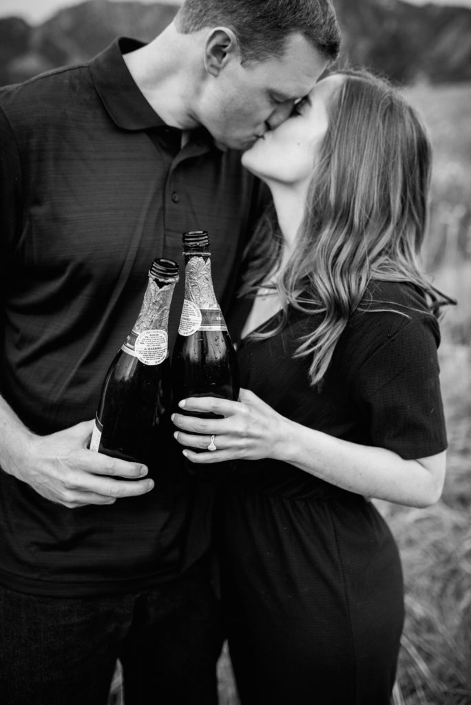 black and white kissing with champagne