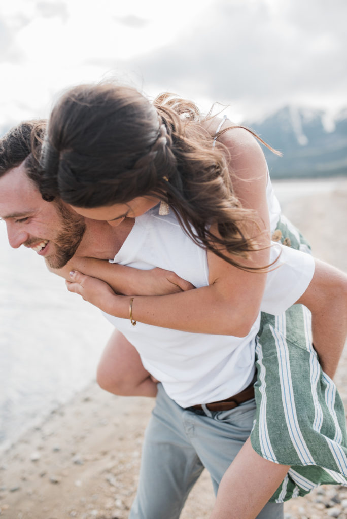 Twin Lakes Engagement laughing couple piggy back