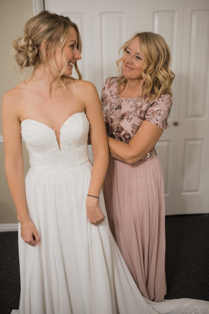 Emily and her mom putting dress on 
