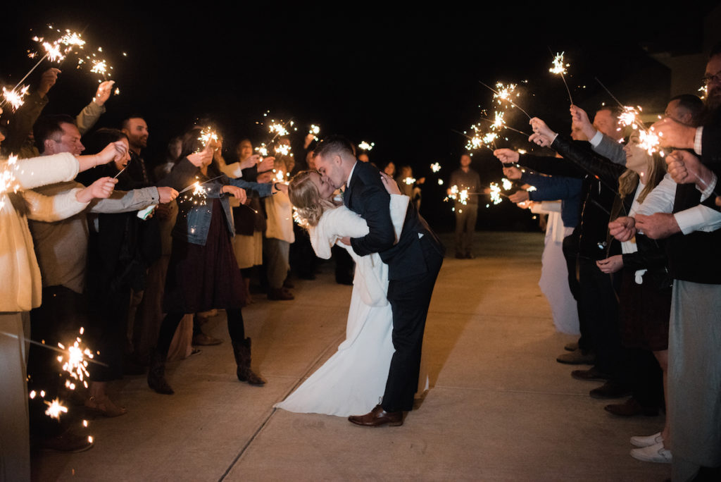 Emily and Andrew exiting with sparklers at Heber City wedding