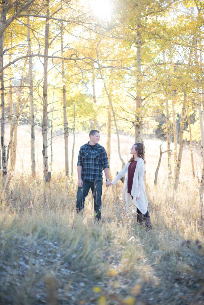 couple standing in aspen grove colorado fall engagement photos