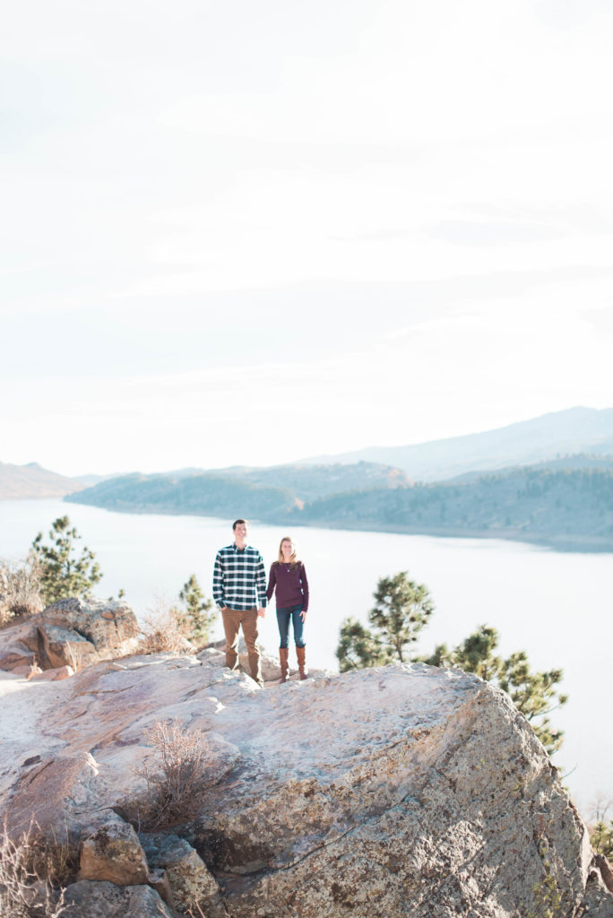 couple standing on horsetooth rock for engagement photos