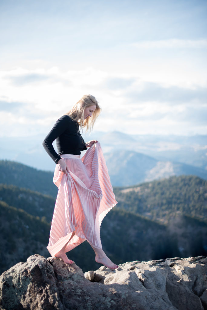 woman with flowy pink skirt Colorado mountaintop boulder portraits