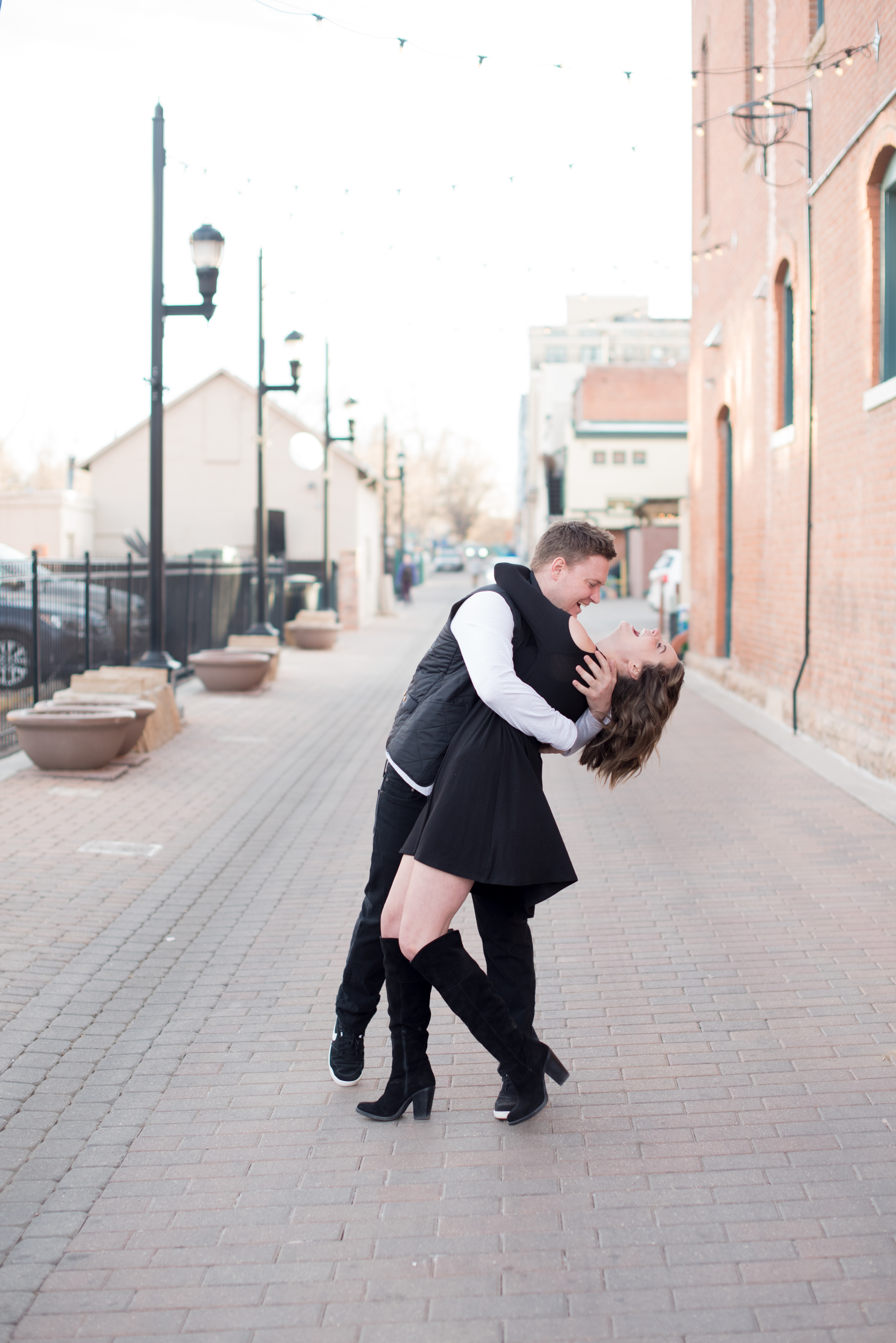 couple dancing in alley at fort collins engagement photoshoot