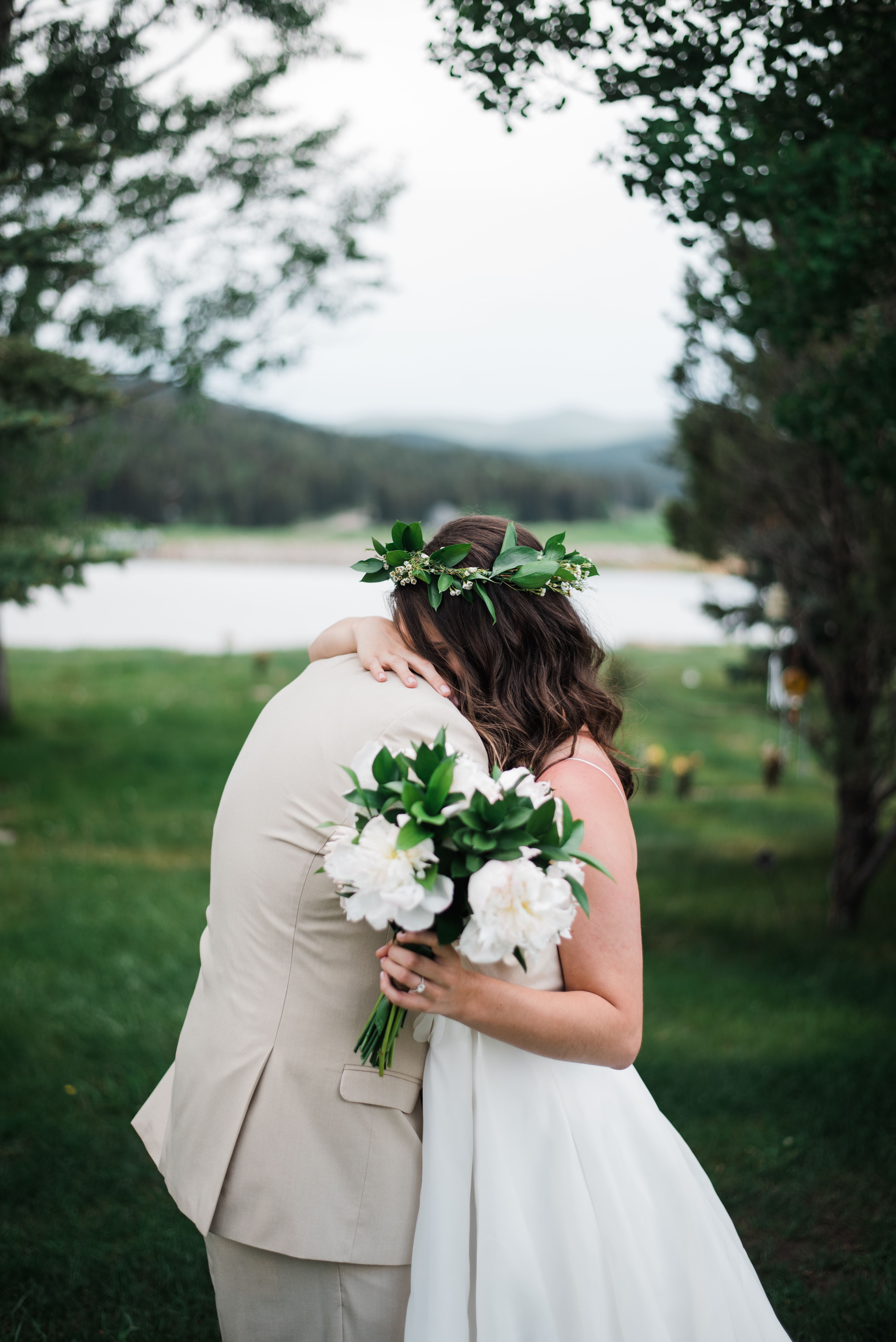 colorado evergreen barn wedding bride and groom hugging