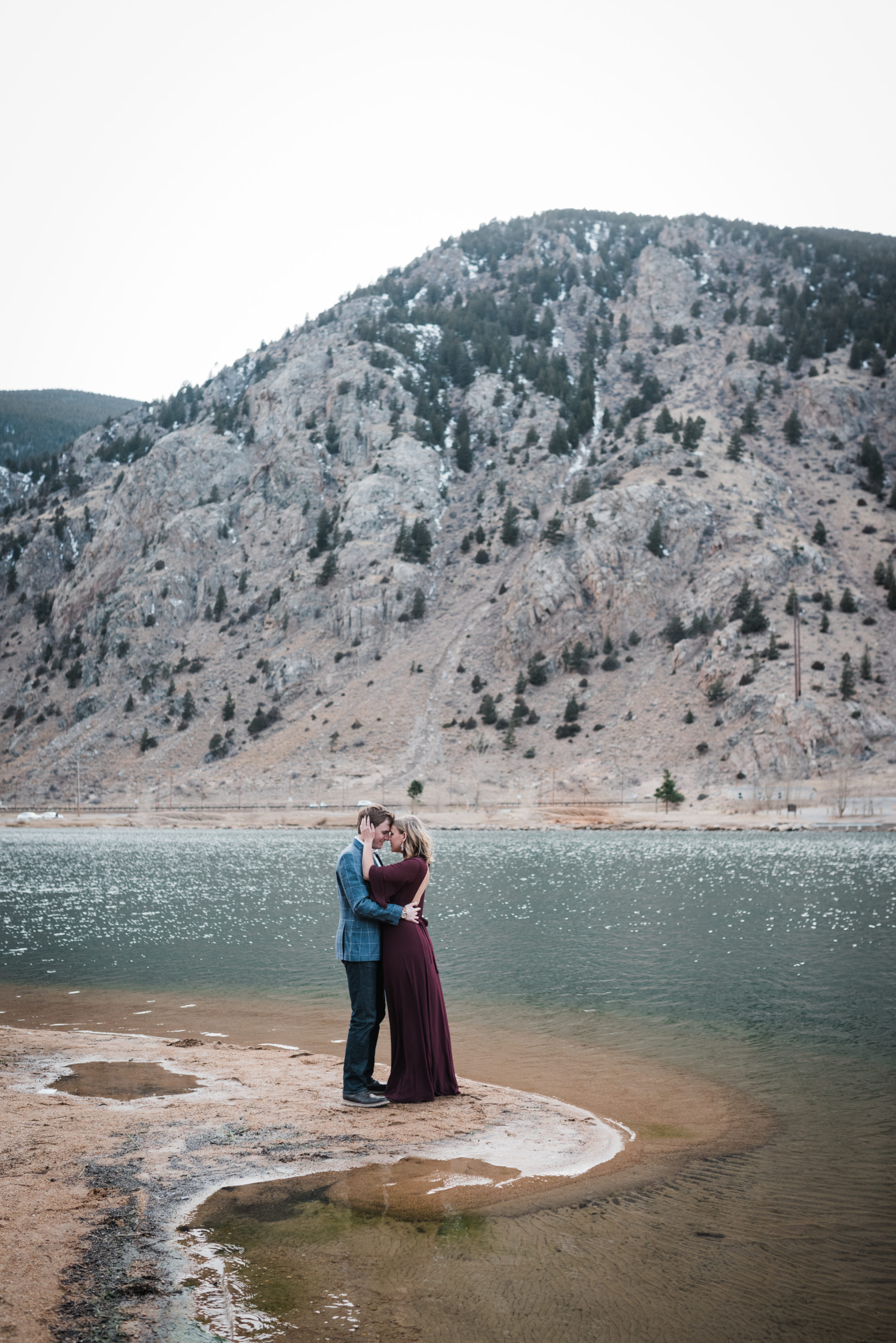 couple on lake shore at georgetown mountain engagement photoshoot