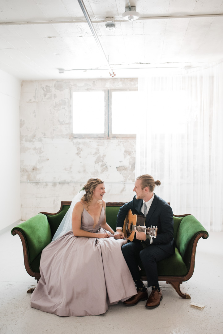 modern summer wedding at the st. vrain on a green couch