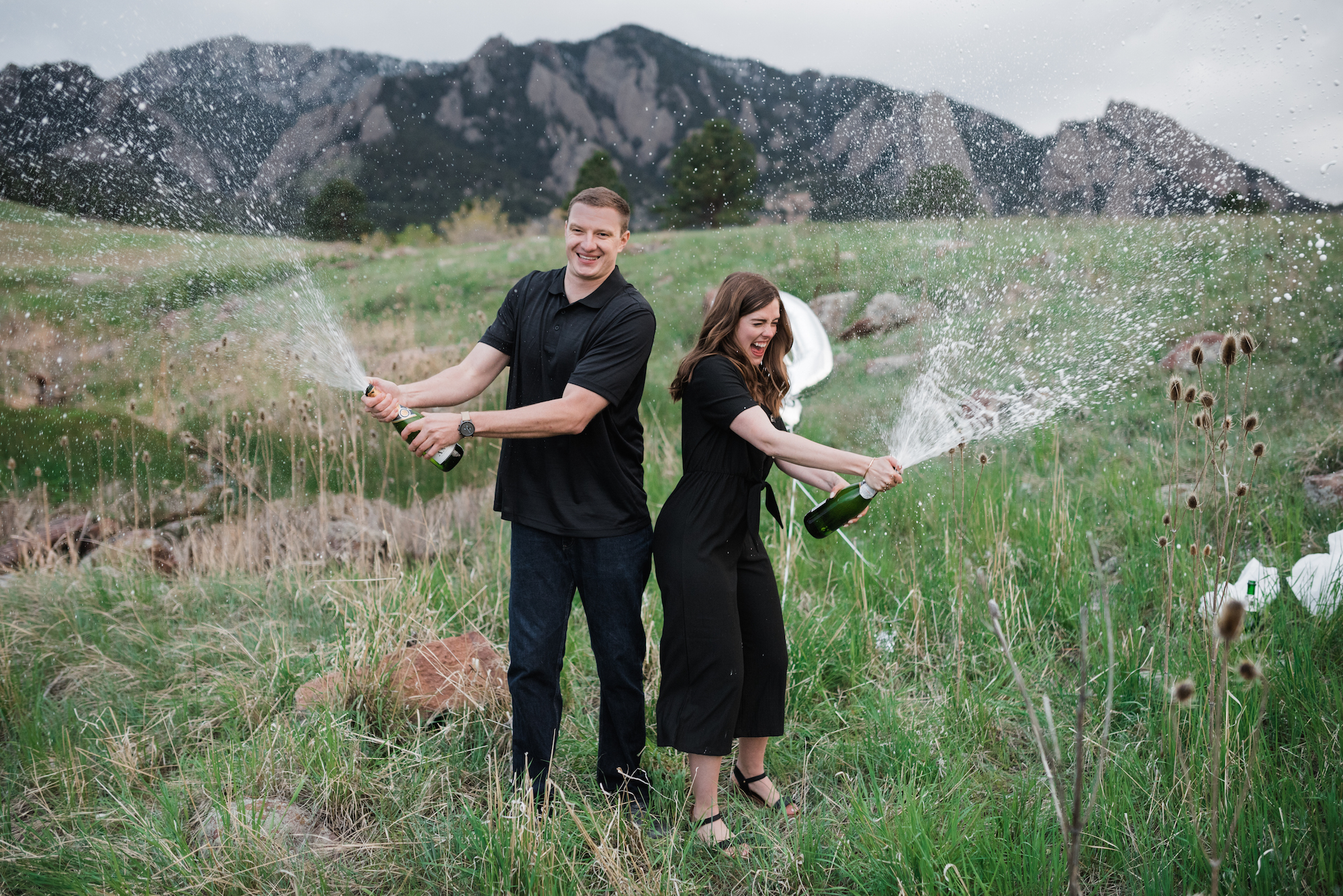 popping champagne at Boulder Colorado engagement photoshoot