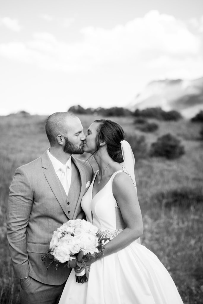 Drew and Kristine kissing at Estes Park Wedding