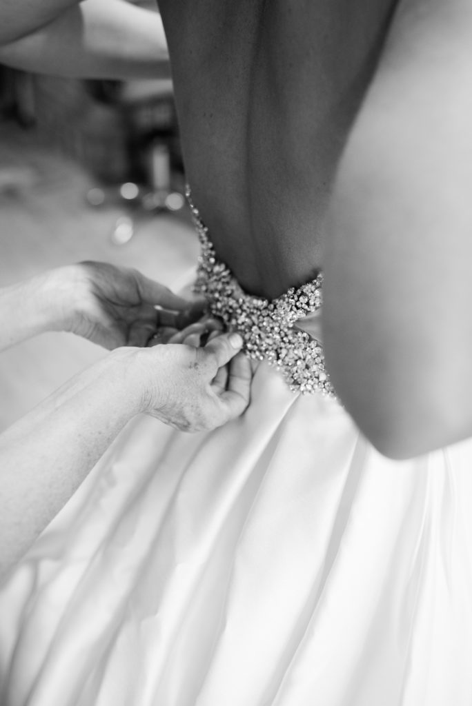 Mom helping put dress on: black and white