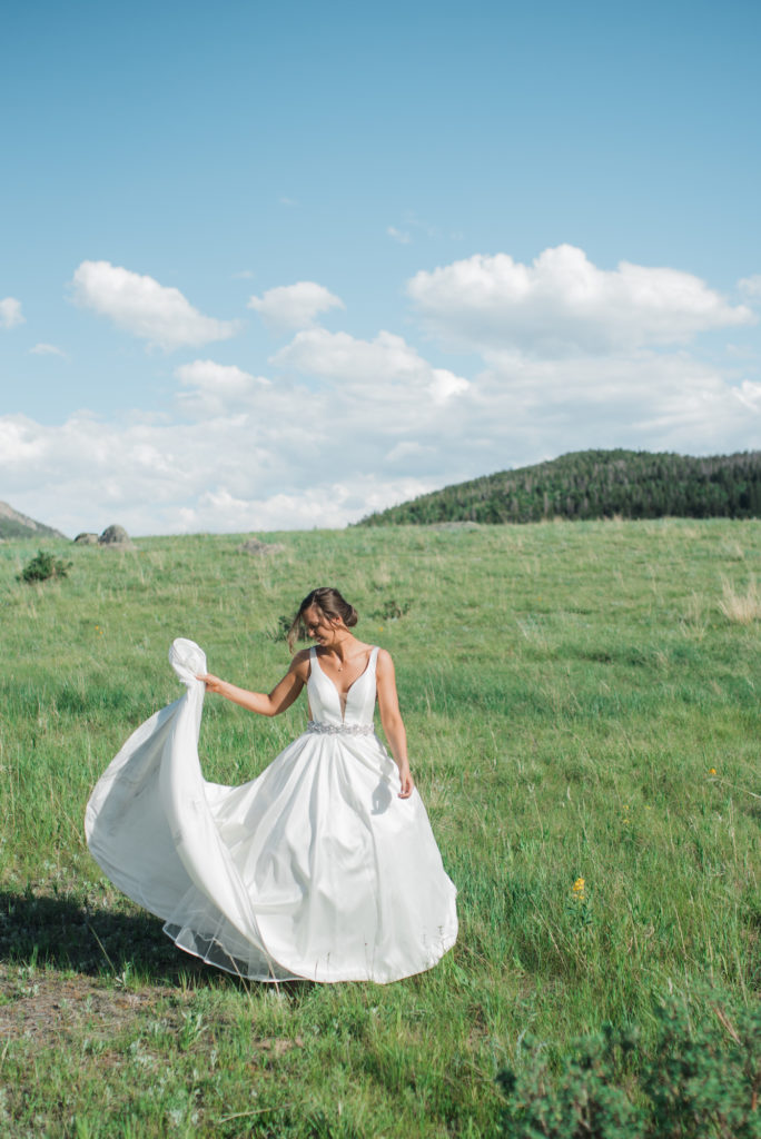 Kristine twirling in dress at Estes Park wedding
