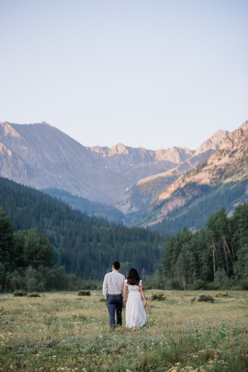 Couple in field at Aspen engagement 
