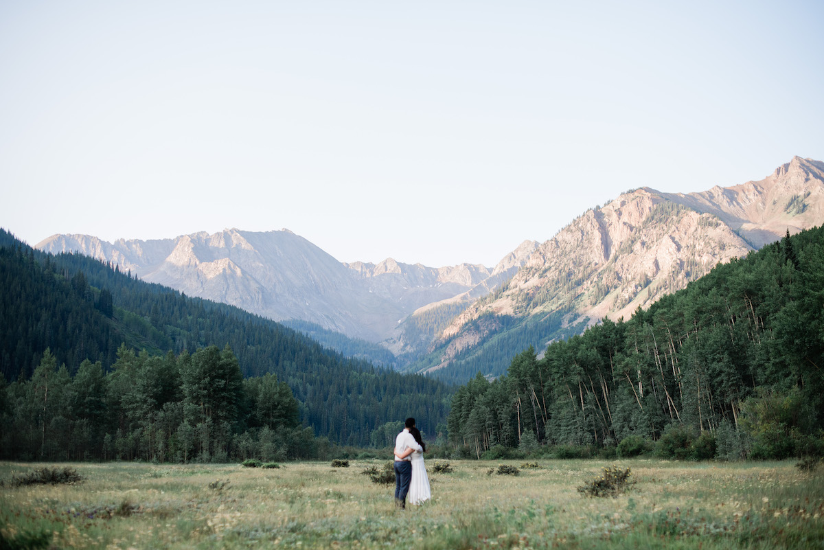 Couple in field at Aspen engagement 