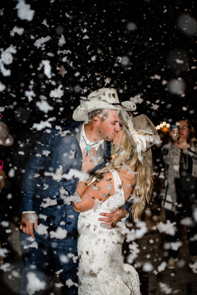 Bride and groom kissing in the snow at Cloud Nine wedding 